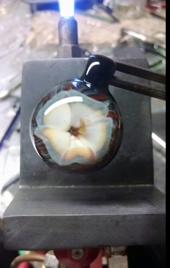 A flower pendant at the torch by Jose Valdes