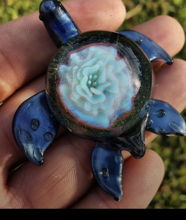Blue borosilicate glass turtle with an implosion flower shell by Jose Valdes